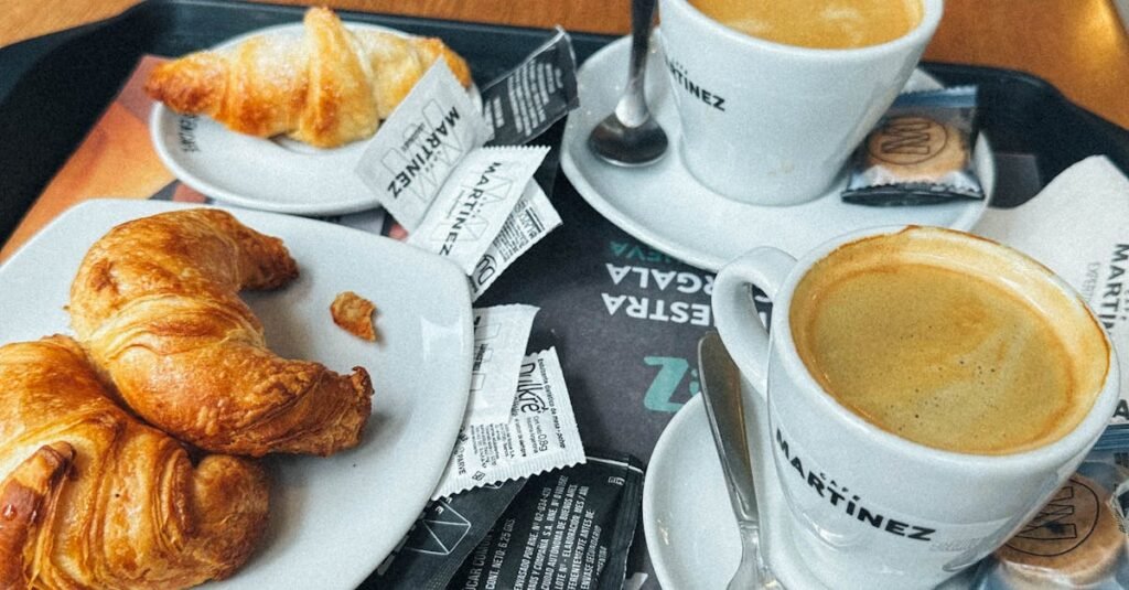 Enjoy a delightful breakfast featuring cappuccino and croissants at a café in Buenos Aires.