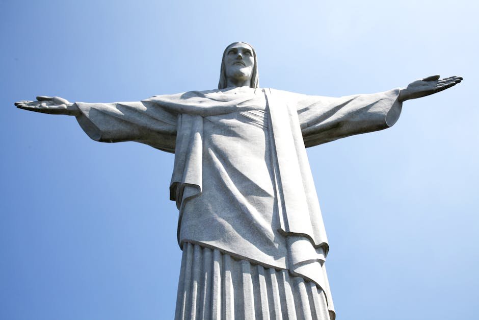 Iconic Christ the Redeemer statue under clear blue sky in Rio de Janeiro, Brazil.