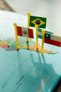 Close-up of flags of South American countries on a world map, highlighting geography and location.